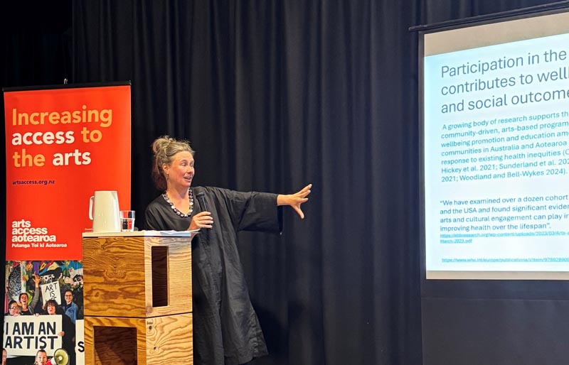 Molly Mullen presents on-stage at the Shifting the Stream forum in 2025